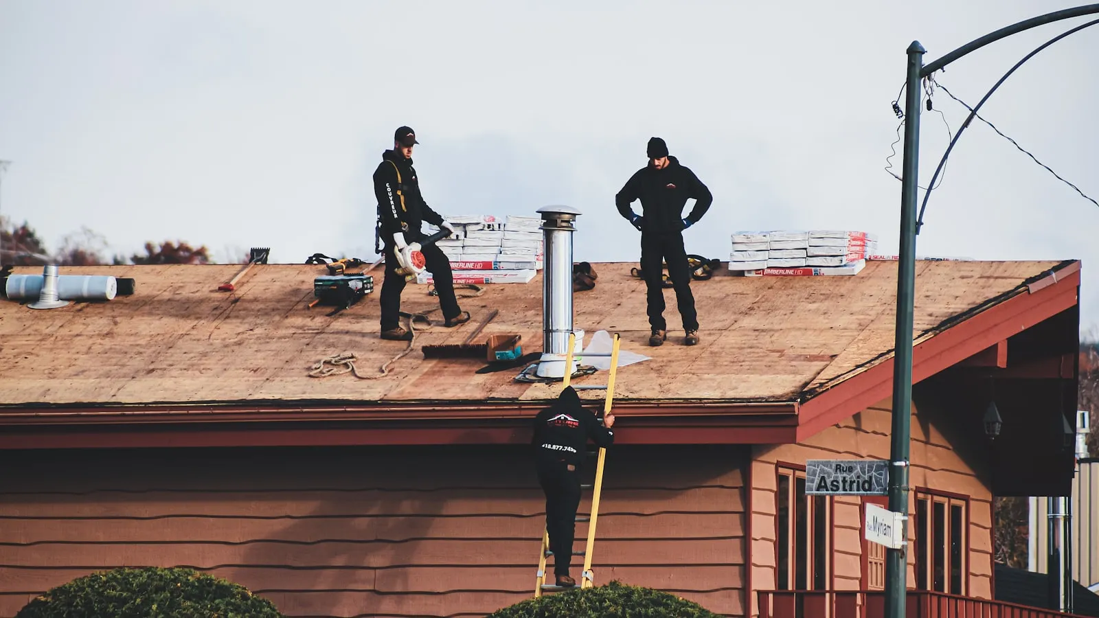 Roofing crew replacing the decking and shingles on a residential roof